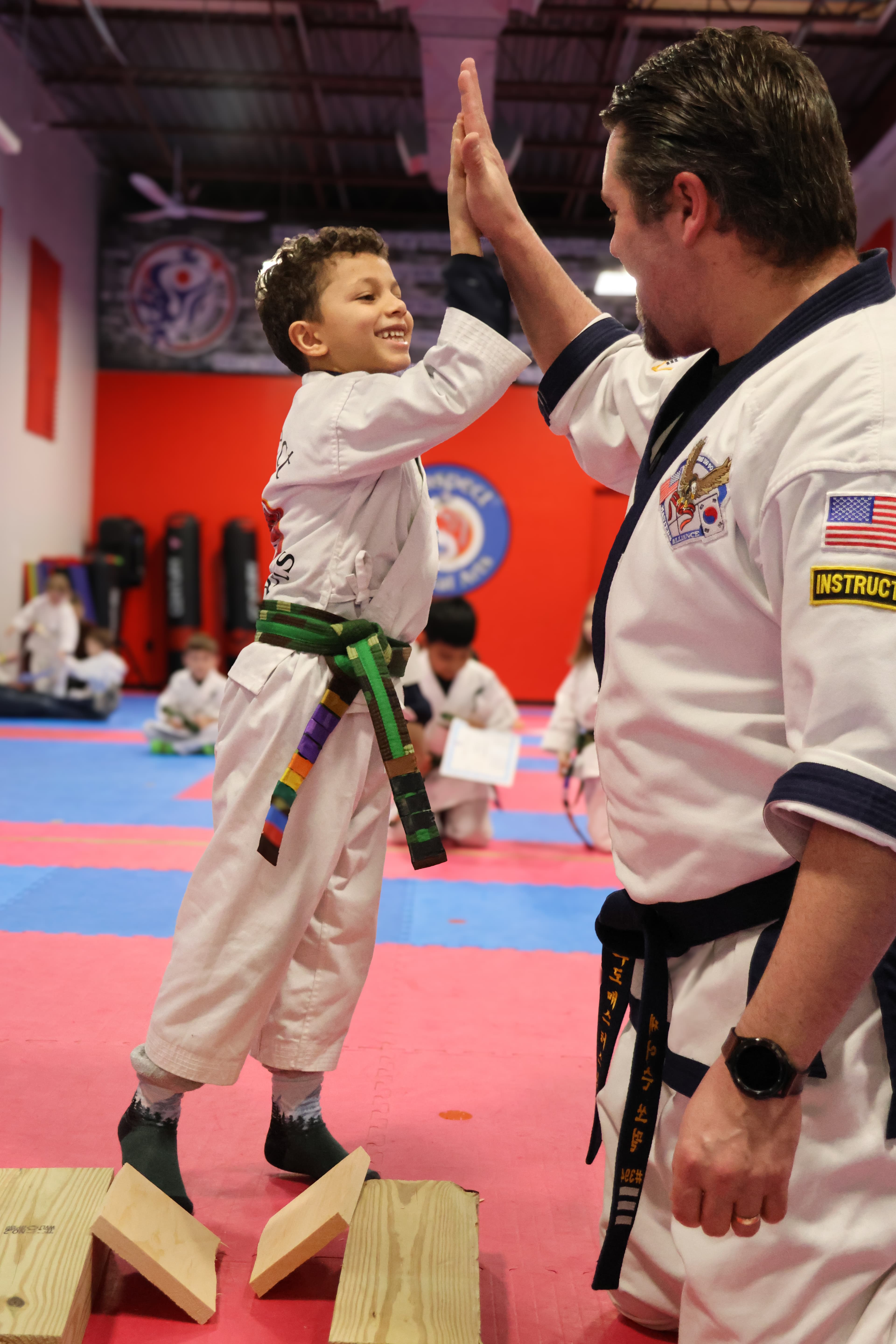Student celebrating a board break with a high five