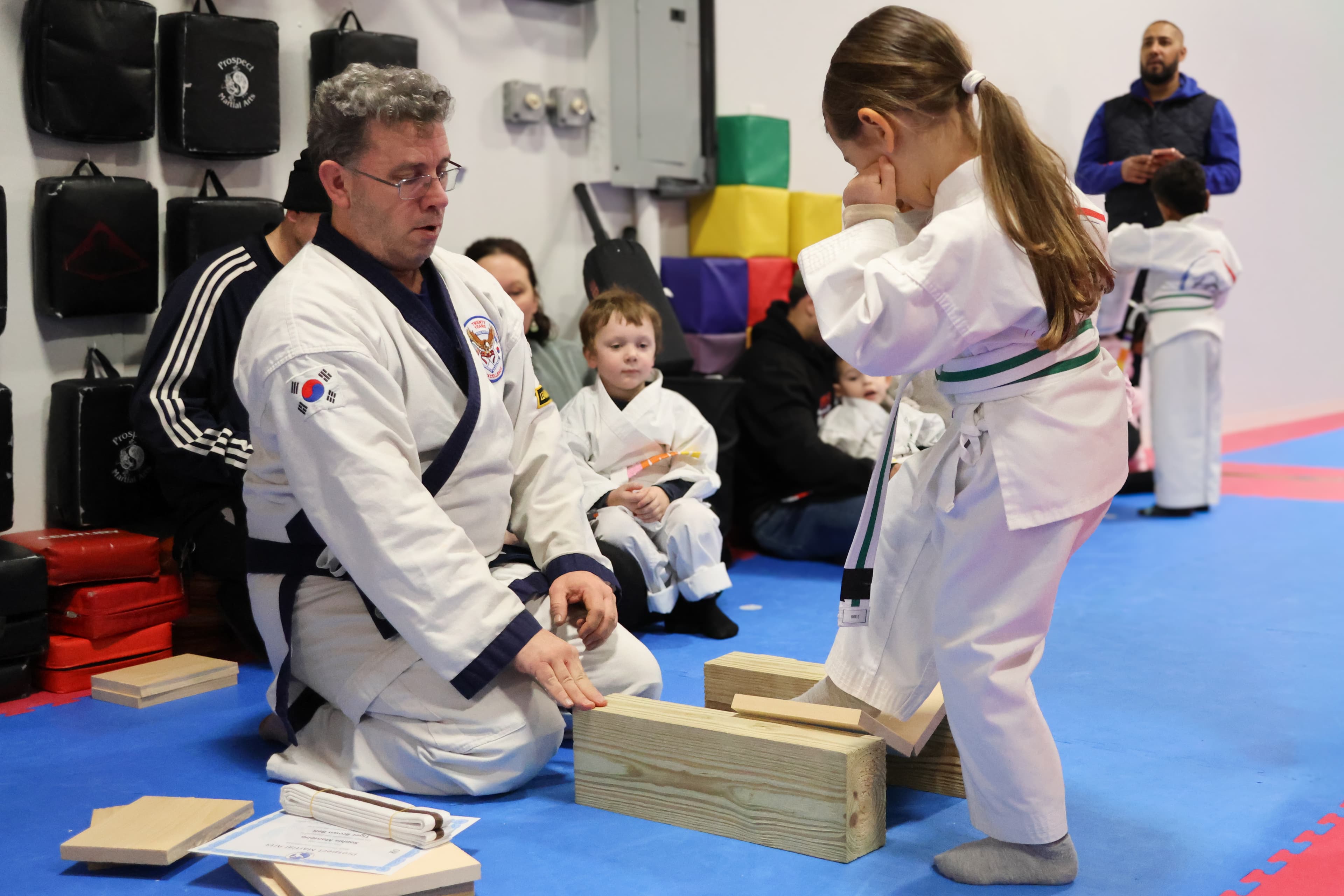 Young student practicing a foot stomp with instructor